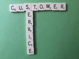 Words customer service spelled out with scrabble pieces