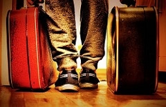 Low angle of Person standing beside two suitcases