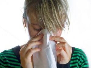 Woman blowing her nose 