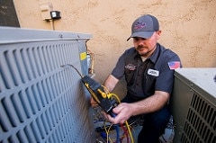 HVAC contractor working on air conditioner