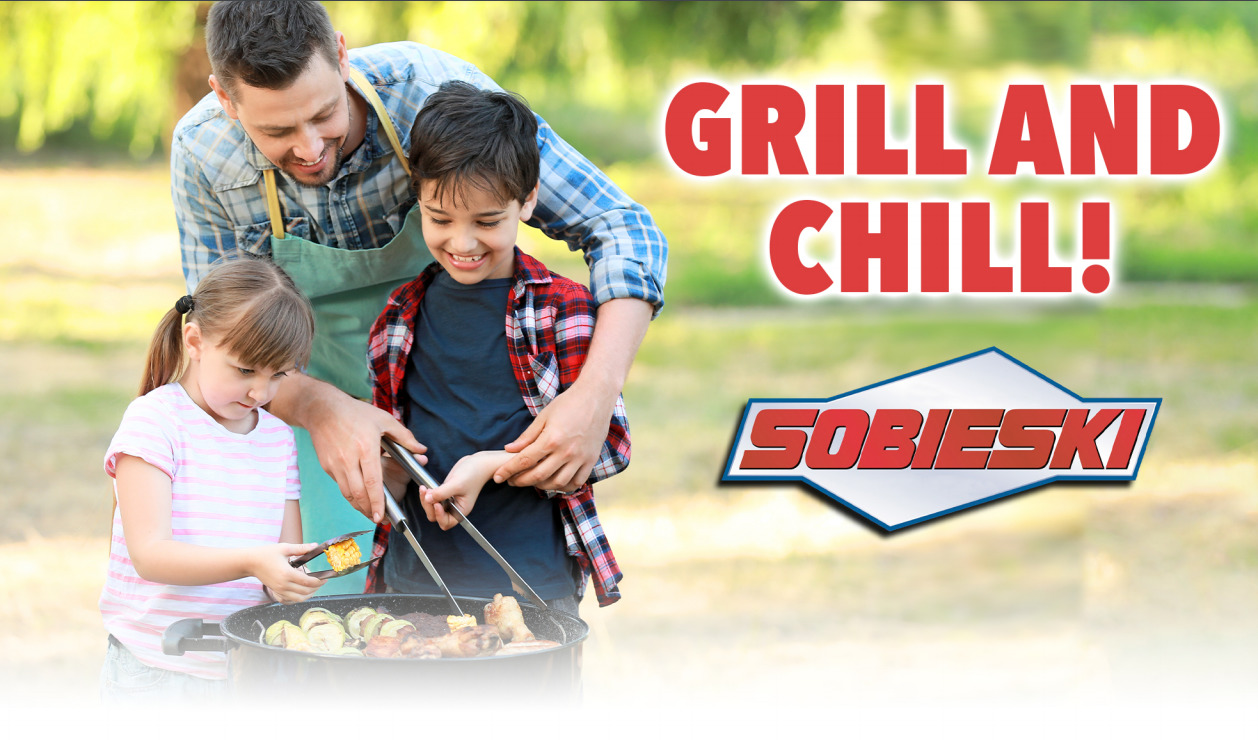 Grill and Chill! Father outside grilling with son and daughter