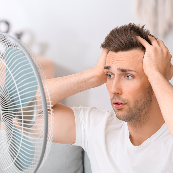 confused man infront of a fan